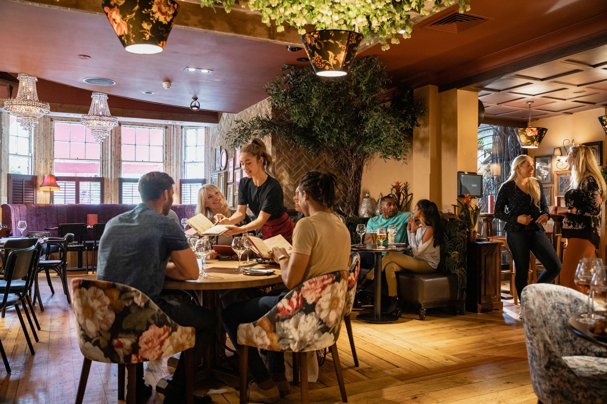 Guests enjoying lunch inside a lively restaurant dining room